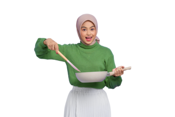 Shocked beautiful Asian woman in green sweater and hijab holding spoon and pan while doing housework isolated on transparent background