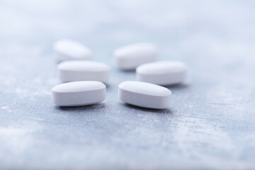 Amino acids tablets on wooden background. Soft focus. Close up