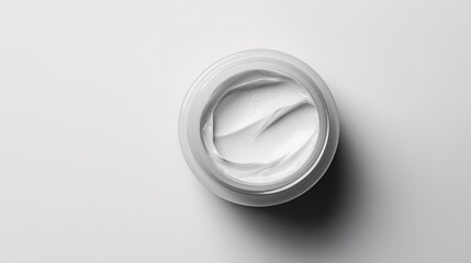minimalist open cosmetic jar with cream on white surface for beauty and skincare advertising