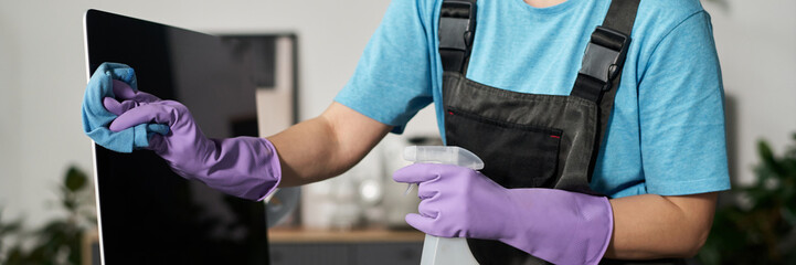 Header with woman wiping screen of computer