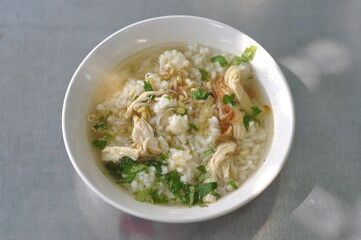 A bowl of warm chicken soto is served on the table