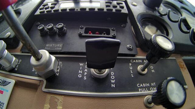 Low Angle CU Airplane Cockpit of Pilot Selecting Wing Flaps Switch