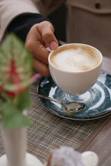 Enjoying a warm cup of coffee in a cozy cafe setting