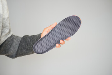 Showing a sole insert made of fabric and rubber in a hand