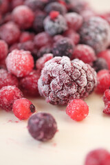 Frozen berries scattered on a light surface in a creative arrangement