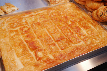 Delicious layers of pastry squares in a bakery display case