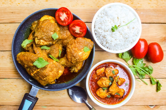 Chicken curry and rice dish on wooden table