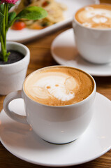 a cup of cappuccino coffee with latte art