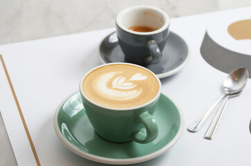 a cup of cappucinno with latte art