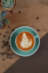 flat lay angle of a cappuccino with latte art in a tosca cup