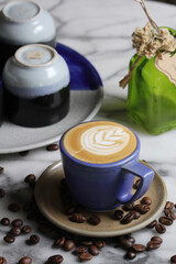 cappuccino with latte art in blue coffee cup