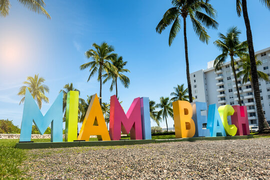 Miami Florida colorful tourist sign under palm trees in South Beach