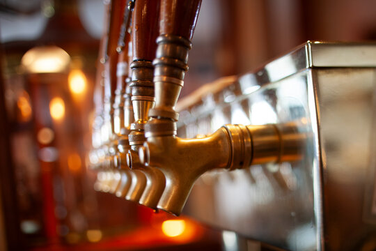 Brass beer taps with wood handles at brewery