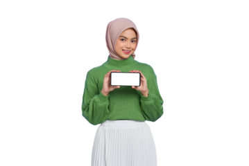 Smiling beautiful Asian woman in green sweater and hijab showing blank screen mobile phone isolated on transparent background