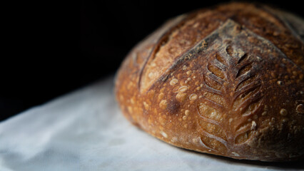 A close-up view of crusty sourdough bread showcasing its golden, textured crust and airy crumb, highlighting artisan craftsmanship and fresh, wholesome, homemade quality.