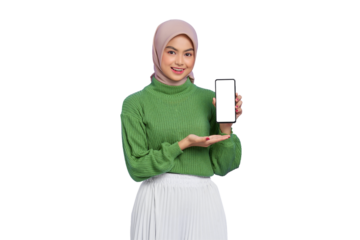 Smiling beautiful Asian woman in green sweater and hijab showing blank screen mobile phone isolated on transparent background