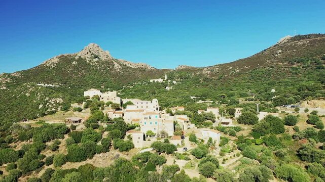 The panoramic view of Pigna reveals an arid and green patchwork, in Europe, in France, in Corsica, on the edge of the Mediterranean Sea, in summer, on a sunny day.&nbsp;