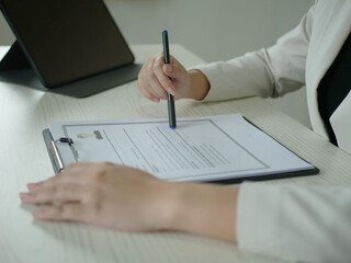 Female HR staff is reviewing resumes to hire candidates, analyzing data before interviews, evaluating documents to offer jobs and select candidates, close-up, recruiting personnel