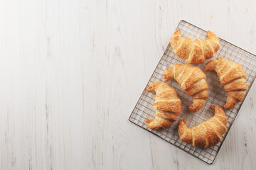 french pastry croissant on a cooling rack