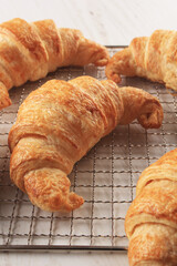 close up croissant french pastry on a rack