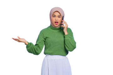 Shocked beautiful Asian woman in green sweater and hijab talking on mobile phone with open mouth isolated on transparent background
