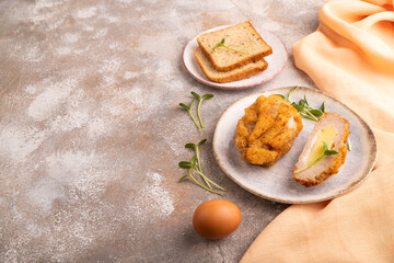Chicken schnitzel on blue plate with microgreen on brown concrete. Diet, healthy eating. side view, copy space
