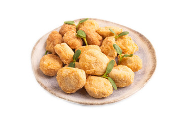 Fried crispy Chicken Nuggets with ketchup, microgreen isolated on white. side view, close up