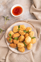 Fried crispy Chicken Nuggets with ketchup, microgreen on brown concrete. Diet, healthy eating. top view, close up