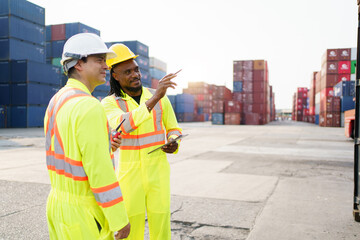 Engineers team or shipyard officers inspecting a containers in container yard.