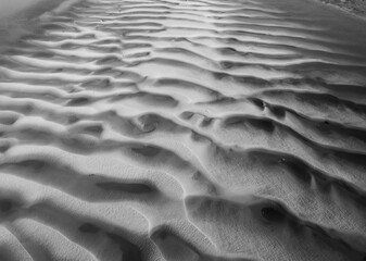 Close up abstract view of sand patterns in black and white