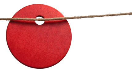 A red circular sale tag hanging from a string isolated on white background