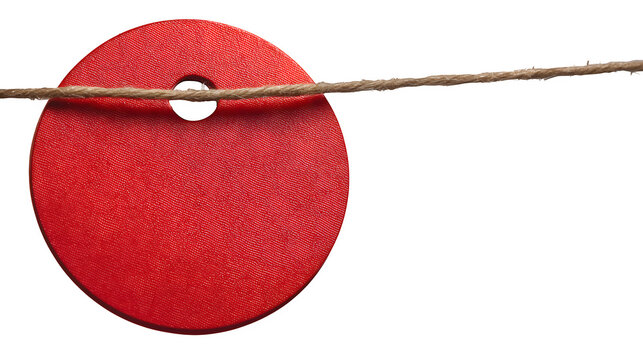 A red circular sale tag hanging from a string isolated on white background