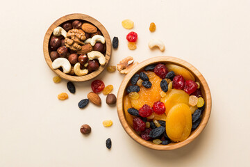 healthy snack: mixed nuts and dried fruits in bowl on table background, almond, pineapple, cranberry, cherry, apricot, cashew