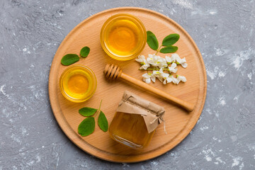 honey jar with acacia flowers and leaves. fresh honey top view flat lay