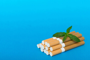 Menthol cigarettes and fresh mint leaves on colored background, Many cigarettes stacked together top view flat lay