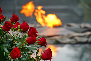 Flowers on the background of eternal flame. Memorial Day, May 9th.