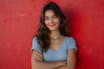 Fototapeta premium Confident and Stylish Young Woman Exudes Empowerment and Grace Against Striking Red Backdrop