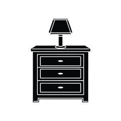 Silhouette of a drawer, a lamp, and a book on top