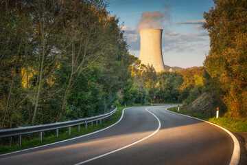 Cooling tower in geothermal power plant and a winding road. Larderello, Italy