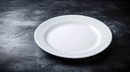 White plate sits on a black countertop. The plate is empty and has a clean, minimalist appearance