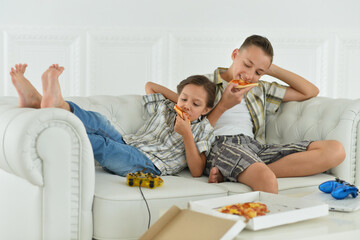 Kids Eating Pizza on the Couch