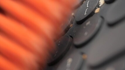 Cleaning a keyboard to remove crumbs and dust buildup