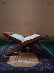 a Muslim holy book is open on the shelf where the Al-Quran is placed