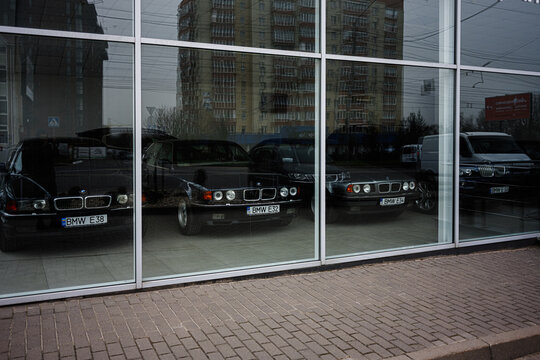 Showroom display of BMW vintage cars viewed through glass exterior