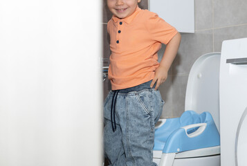 kid climbing on ladder from potty training seat and smile,making funny faces and grimaces.baby boy...