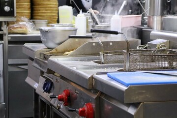 A Modern Commercial Kitchen Equipped with Various Cooking Equipment Including Fryers