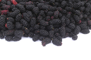 Heap of mMulberry berries isolated on white background.