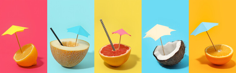 Set of fruits with decorative umbrellas on color background