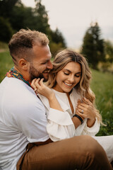 Fototapeta premium Happy couple embracing and smiling outdoors in nature
