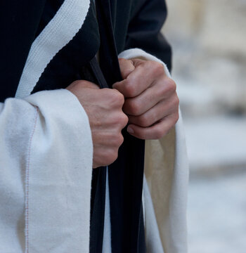 Close-up of a Catholic clergyman's hands and clergy robes